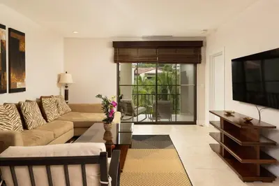 a living room with a couch and a tv at 3-Bedroom 2-Bath Condo Overlooking Pool in Coco