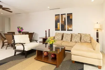 a living room with a couch and a table at 3-Bedroom 2-Bath Condo Overlooking Pool in Coco