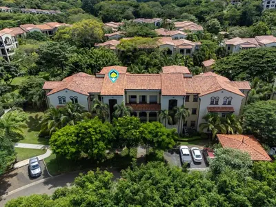 an aerial view of a large house with trees at Luxe 3-BD Condo on 2nd Floor Above Pool in Coco