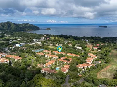 an aerial view of a resort near the water at Luxe 3-BD Condo on 2nd Floor Above Pool in Coco