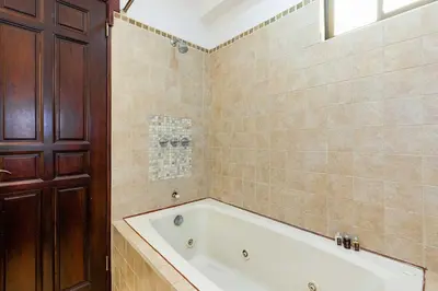 a bathroom with a bath tub and a window at Newly remodeled unit in Flamingo with sweeping ocean views from big terrace in Playa Flamingo
