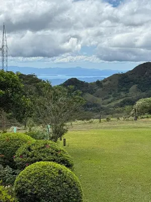 a green field with mountains in the background at Campo Azul #3 - Monteverde in Monteverde Costa Rica