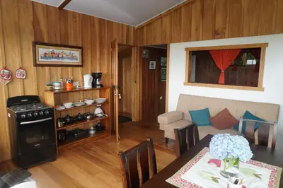 a kitchen and living room with a table and a stove at Campo Azul #3 - Monteverde in Monteverde Costa Rica
