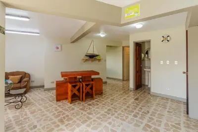 a living room with a table and a couch at Las Carmelas, Airport Juan Santamaría, Alajuela, San José in Alajuela City