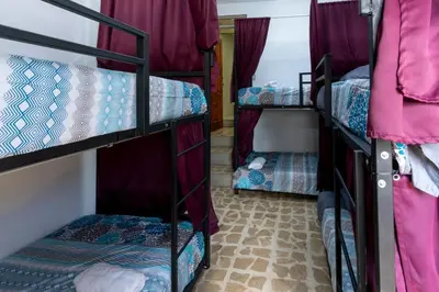 a room with three bunk beds in a room at Las Carmelas, Airport Juan Santamaría, Alajuela, San José in Alajuela City