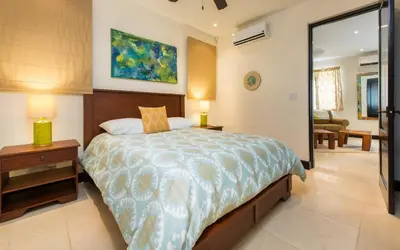 a bedroom with a large bed and a living room at Calle La Ronda 15 At Las Catalinas in Playa Danta