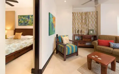 a bedroom with a bed and a chair and a couch at Calle La Ronda 15 At Las Catalinas in Playa Danta