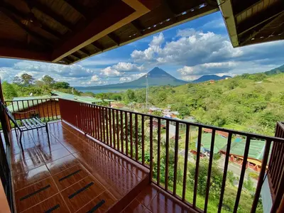 a balcony with a view of a mountain at Chateau Arenal Hotel & Restaurante in El Castillo de La Fortuna