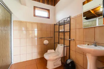a bathroom with a toilet and a sink at Chateau Arenal Hotel & Restaurante in El Castillo de La Fortuna