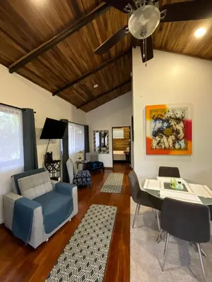 a living room with a blue couch and a table at Casa Cooper in Carrillo