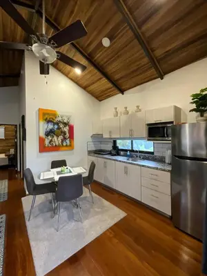 a kitchen with a dining table and a ceiling fan at Casa Cooper in Carrillo