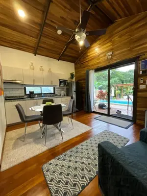 a kitchen and living room with a table and chairs at Casa Cooper in Carrillo