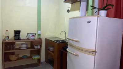 a kitchen with a white refrigerator and a shelf at Casa Rural Aralia in Fortuna