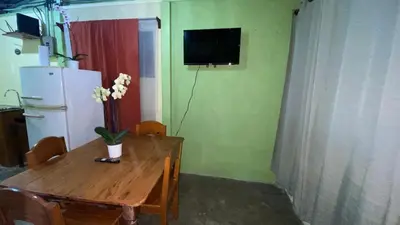 a kitchen with a wooden table and a refrigerator at Casa Rural Aralia in Fortuna