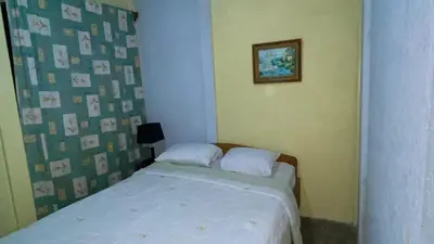 a small bedroom with a bed and a picture on the wall at Casa Rural Aralia in Fortuna
