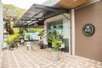 a restaurant with people sitting outside of a building at Bright & Airy new Condo, 5 min walk to Jaco Beach! in Jacó