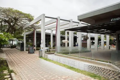 a shopping center with a building in the background at Bright & Airy new Condo, 5 min walk to Jaco Beach! in Jacó