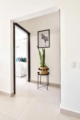 a room with a potted plant on a table at Bright & Airy new Condo, 5 min walk to Jaco Beach! in Jacó
