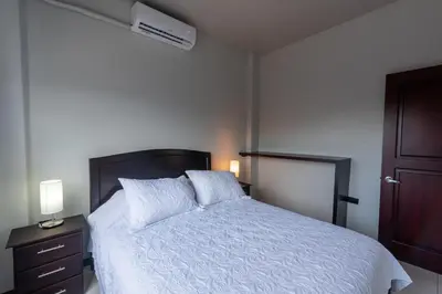 a bedroom with a bed with a white comforter at Villas Fortuna Boutique in Fortuna
