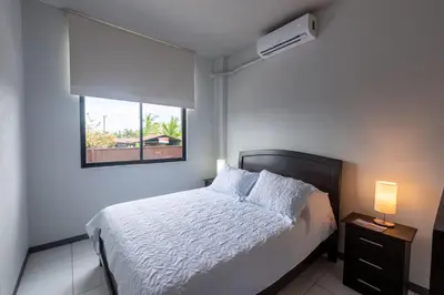 a bedroom with a white bed and a window at Villas Fortuna Boutique in Fortuna