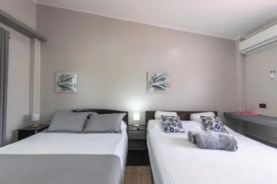 two beds sitting next to each other in a room at Villas Fortuna Boutique in Fortuna