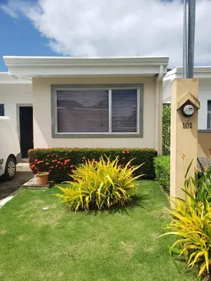 a house with plants in front of it at Casa de playa Herradura con piscina y jacuzzi in Puntarenas