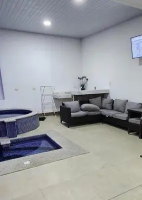 a large living room with couches and a table at Casa de playa Herradura con piscina y jacuzzi in Puntarenas