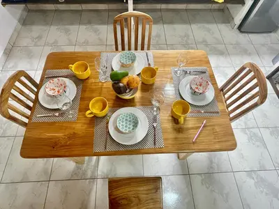 a wooden table with plates of food on it at Casa Paraiso Parrita in Parrita