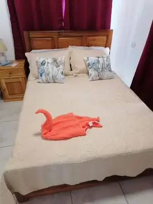 a bedroom with a bed with a red towel on it at Casa Paraiso Parrita in Parrita
