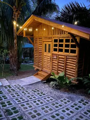 a small wooden house with a pathway in front of it at Sámara Tarantela Houses, Casa Melina in Sámara