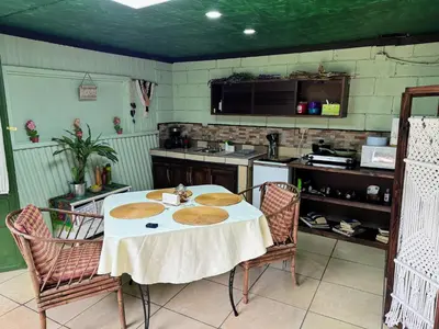 a kitchen with a table with plates on it at Hermosa Cabaña en Cartago! Cabaña Providencia! in Cartago