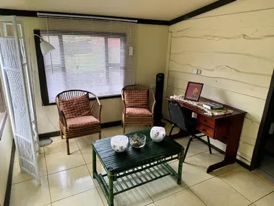 a living room with a table and chairs and a desk at Hermosa Cabaña en Cartago! Cabaña Providencia! in Cartago