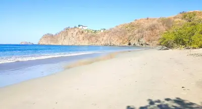 a view of a beach with the ocean at Playa Potrero - Cute, modern Containerhome with pool for 2 people in Potrero