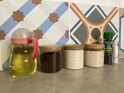 a row of jars on a counter with spices at Nido Aracari in San Pedrillo