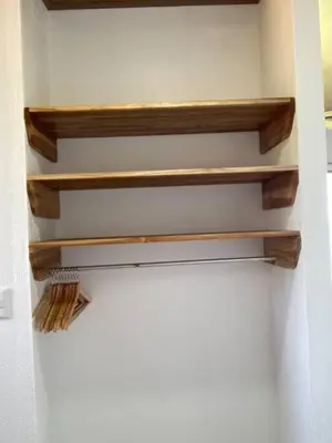 a closet with wooden shelves on the wall at Nido Aracari in San Pedrillo
