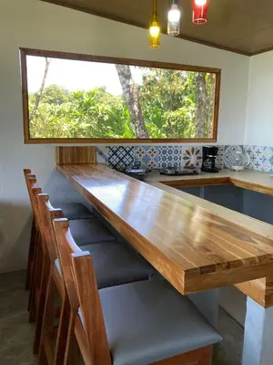 a large wooden table in a kitchen with a window at Nido Aracari in San Pedrillo