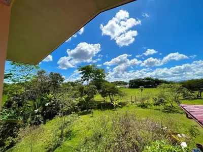 a view of a field from the porch of a house at Apartment Buenos Aires, Puntarenas in Buenos Aires