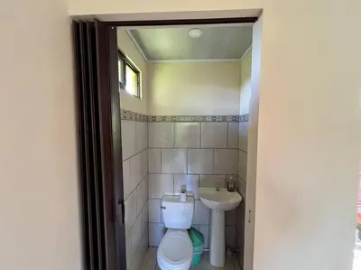 a bathroom with a toilet and a sink at Apartment Buenos Aires, Puntarenas in Buenos Aires