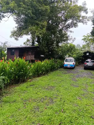 a van parked in a yard next to a house at Chava Camping Rio Celeste in Rio Celeste