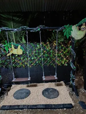 a swing set with two chairs in a playground at Chava Camping Rio Celeste in Rio Celeste