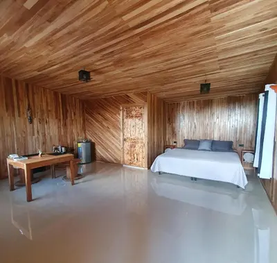 a bedroom with a bed and a wooden ceiling at El Chaguite Monteverde in Monteverde Costa Rica