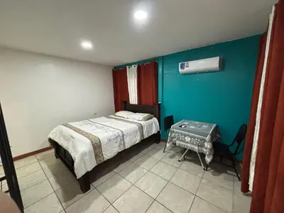 a small bedroom with a bed and a table at Apartamentos Zamora in Puerto Limón