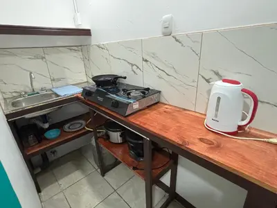 a kitchen counter with a stove and a sink at Apartamentos Zamora in Puerto Limón