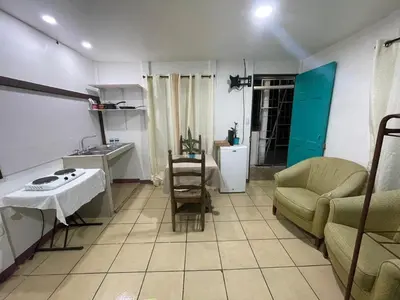 a kitchen and living room with a couch and a table at Apartamentos Zamora in Puerto Limón