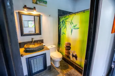 a bathroom with a sink and a toilet at Toucan Villa -riverfront With Pool & Near A Beach in Uvita