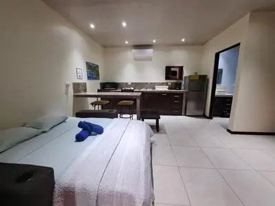 a bedroom with a bed with a blue stuffed animal on it at Casa Uvita Bay in Uvita