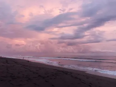 a beach with a cloudy sky and the ocean at Condo Playa Hermosa, Puntarenas in Muñeco