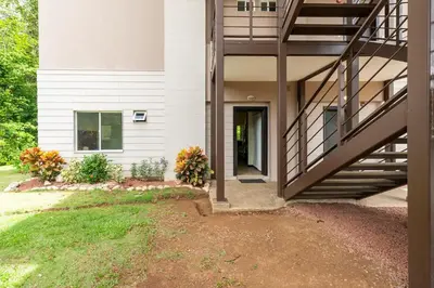 a house with a staircase leading to a door at Condo Playa Hermosa, Puntarenas in Muñeco