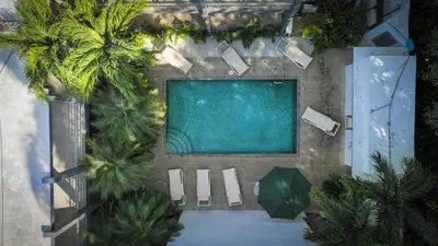 an overhead view of a swimming pool with palm trees at Condo Casa Blanca 7 - NEW 2 BR condo, near to the beach in Potrero