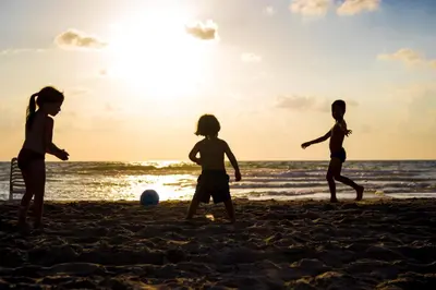 a group of children playing on the beach at Condo Casa Blanca 7 - NEW 2 BR condo, near to the beach in Potrero